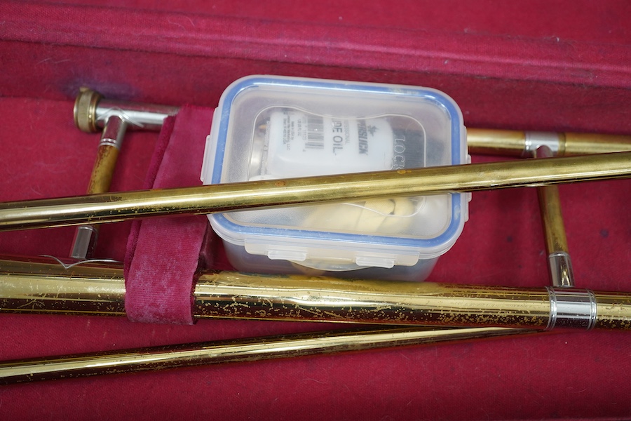 Three student trumpets by Beltone, etc. in soft cases and a cased Boosey & Hawkes trombone. Condition - poor to fair, all play